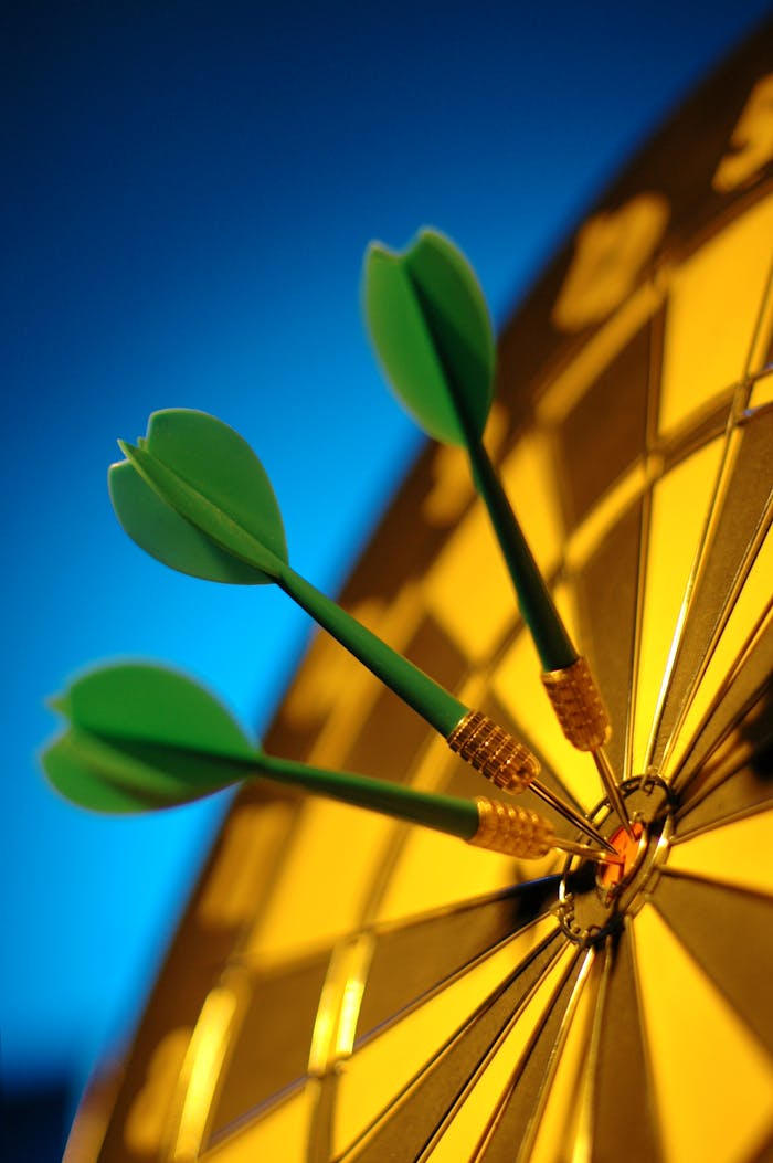 core-values Three green darts hit the bullseye on a dartboard, symbolizing precision.